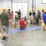 Pups trying on various sledding harnesses and soaking in the great info